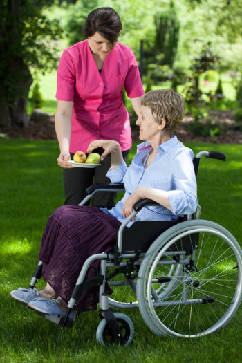 Staff giving apples to patient